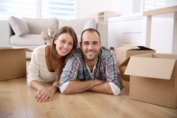 man and woman laying floor near moving boxes in north york home