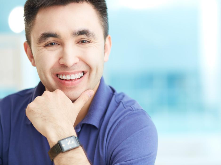 Man smiling with braces from a north york dentist