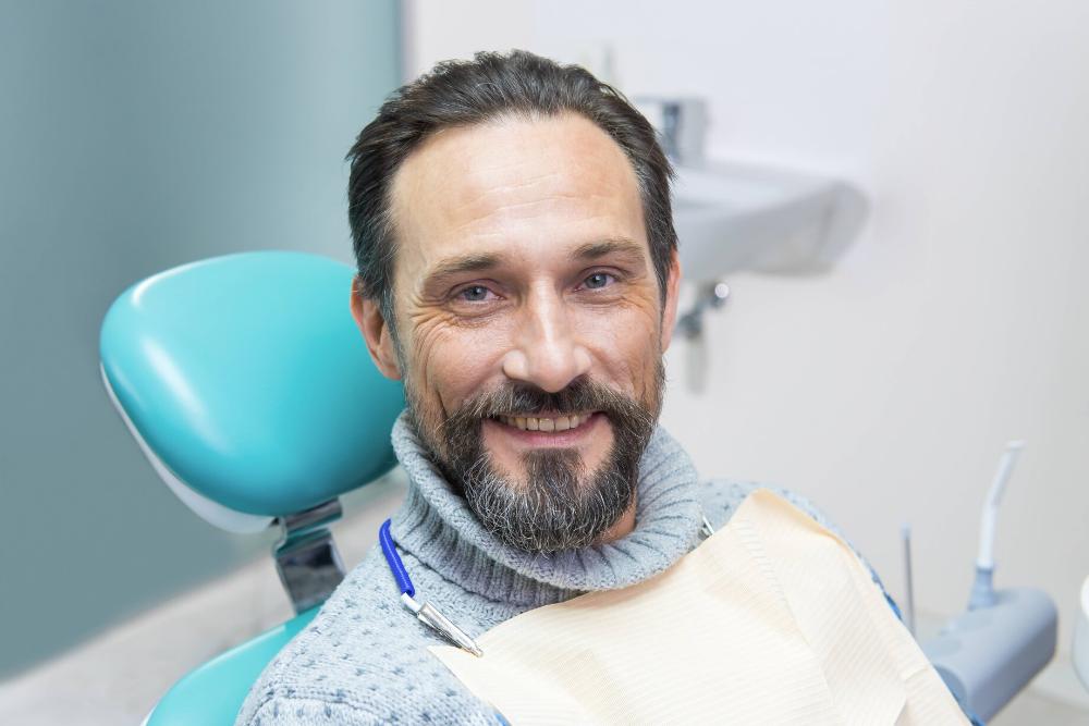 man smiling in dental chair in north york