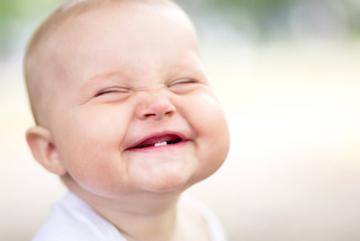 baby smiling with two bottom teeth showing in north york