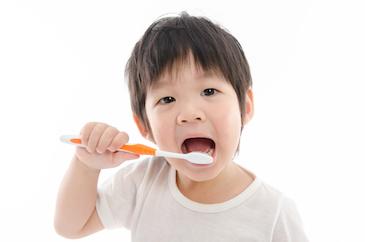 Young boy brushing teeth in north york