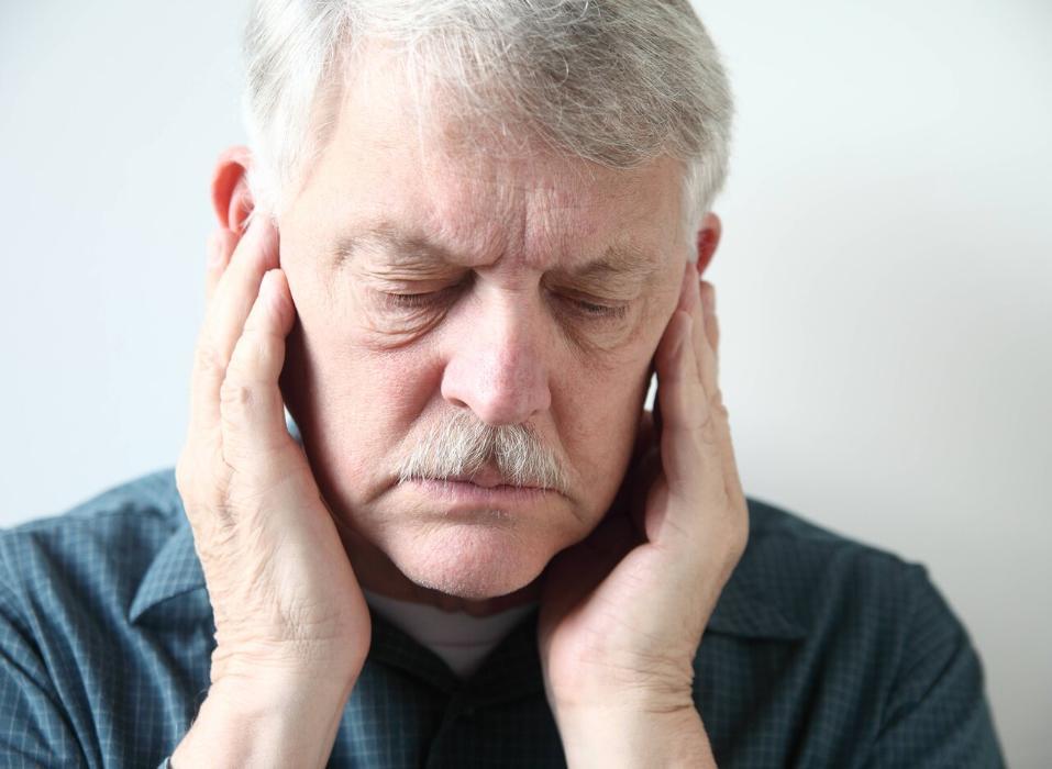 man holding jaw from TMD pain 