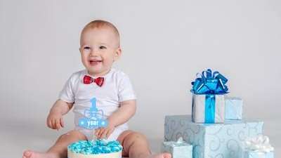 baby sitting by birthday gifts 