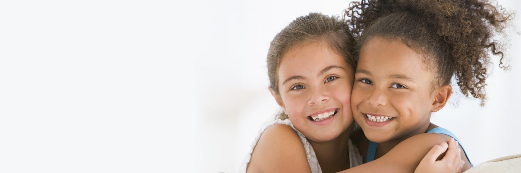 Two young girls hugging in north york on