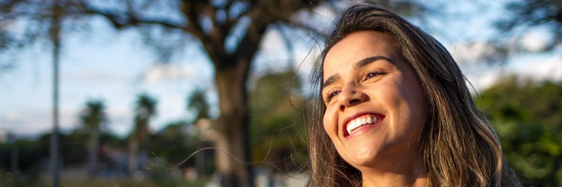 woman smiling outside after getting teeth straightened in north york